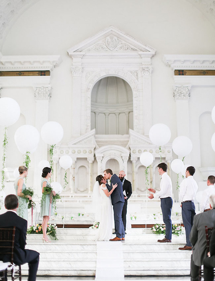 All white minimalist indoor wedding ceremony. These big white balloons give such a fun touch to the ceremony decor while still managing to keep it classy. // ❤ Check Out These Gorgeous 20 Indoor Wedding Ceremony Ideas. // http://mysweetengagement.com/indoor-wedding-ceremony-ideas