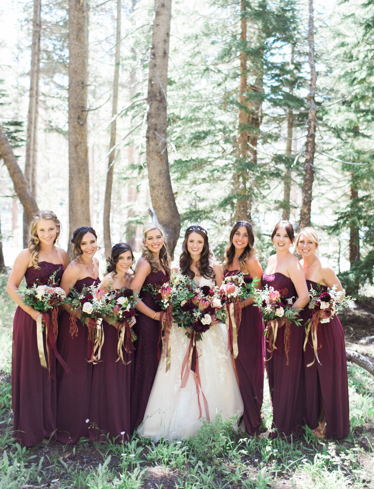 Strapless burgundy bridesmaid dresses with burgundy accent bouquets and ribbon. // Burgundy Bridesmaid Dresses Ideas // http://mysweetengagement.com/burgundy-bridesmaid-dresses/ 