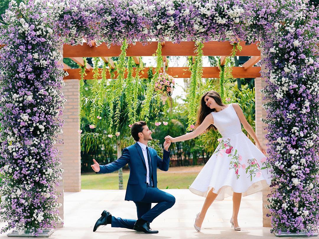 Lovely couple pose idea. The groom is rocking an elegant navy blue suit and the bride a stunning mid length white dress with embroidered flowers. // ❤This civil Wedding is absolutely delightful (Camila Queiroz and Kleber Toledo I Do's) // http://mysweetengagement.com/mid-length-civil-wedding-dress/