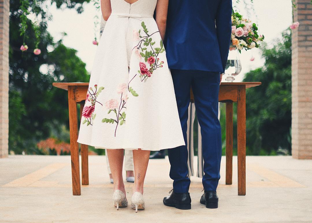 Lovely wedding photo idea. The groom is rocking an elegant navy blue suit and the bride a stunning mid length white dress with embroidered flowers. // ❤This civil Wedding is absolutely delightful (Camila Queiroz and Kleber Toledo I Do's) // http://mysweetengagement.com/mid-length-civil-wedding-dress/