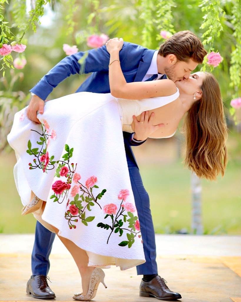 Romantic couple pose idea for a portrait. The groom is rocking an elegant navy blue suit and the bride a stunning mid length white dress with embroidered flowers. // ❤This civil Wedding is absolutely delightful (Camila Queiroz and Kleber Toledo I Do's) // http://mysweetengagement.com/mid-length-civil-wedding-dress/