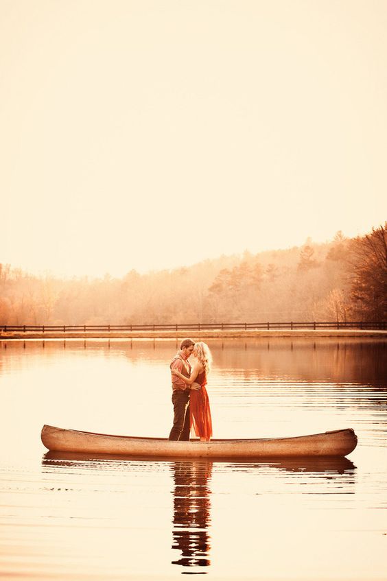 Romantic couple's photography on a boat with orange skies and leaves. // 10 Stunning Fall Engagement Photo Inspirations. // mysweetengagement.com
