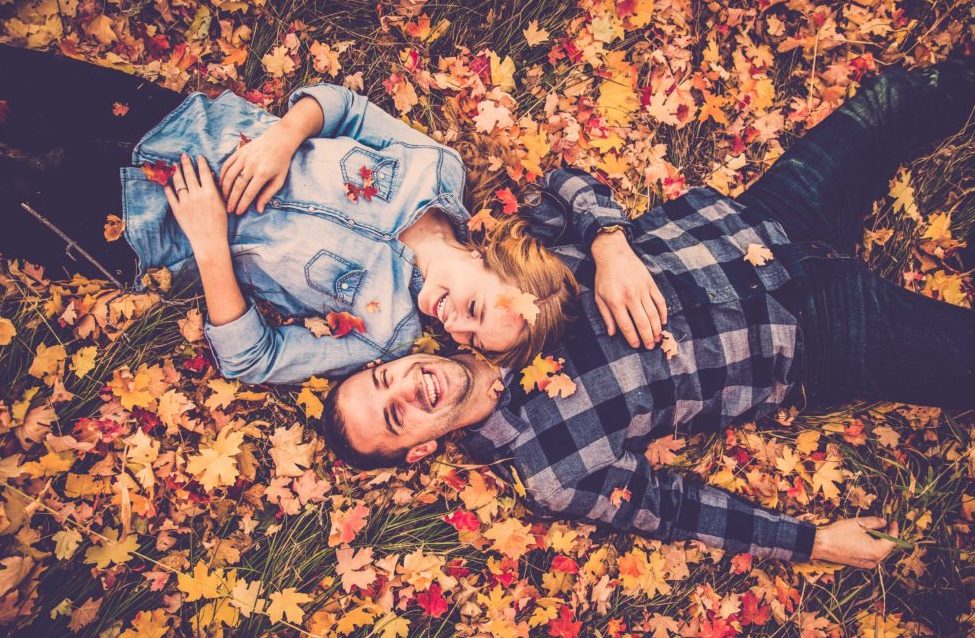 Couple laying down on fall leaves - beautiful and fun engagement photo idea // 10 Stunning Fall Engagement Photo Inspirations. // mysweetengagement.com