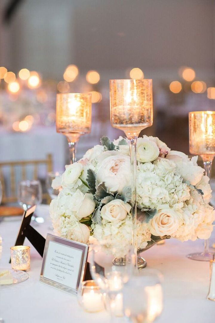Elegant Wedding Centerpiece Idea with Candle Stick and Floral Arrangement. White and Gold palette. // 15 Stunning Ways to Decorate with Candles // http://mysweetengagement.com
