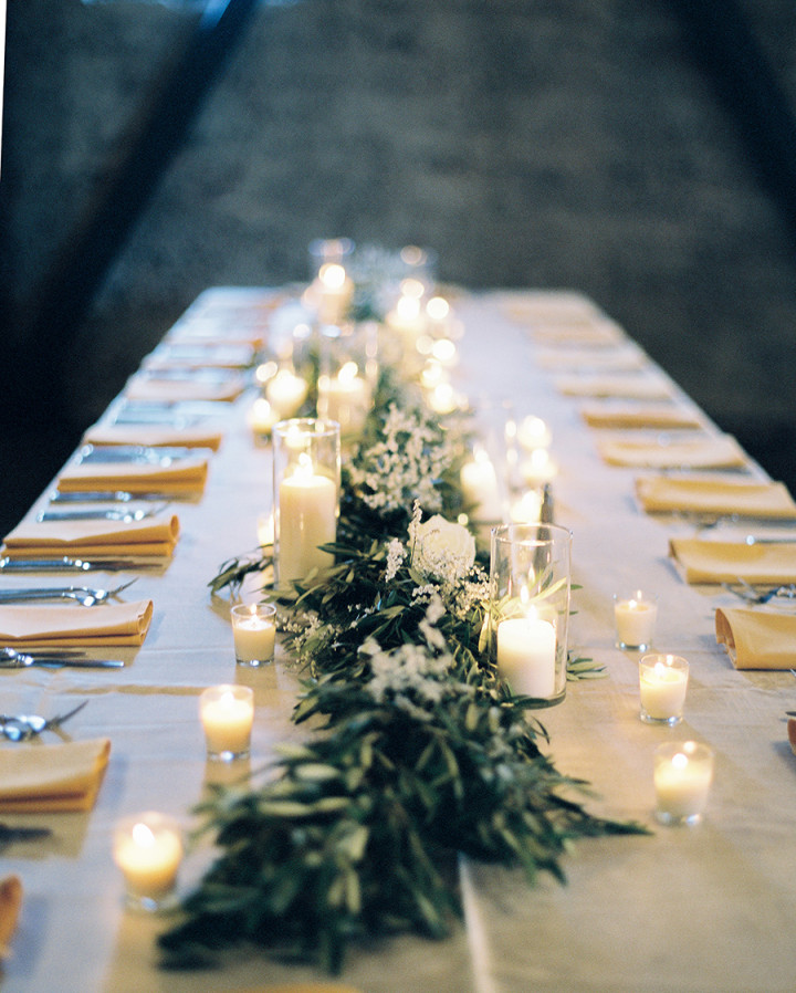 Minimalist Wedding Centerpiece with Greeneries and Different Size Candles. // 15 Stunning Ways to Decorate with Candles // http://mysweetengagement.com