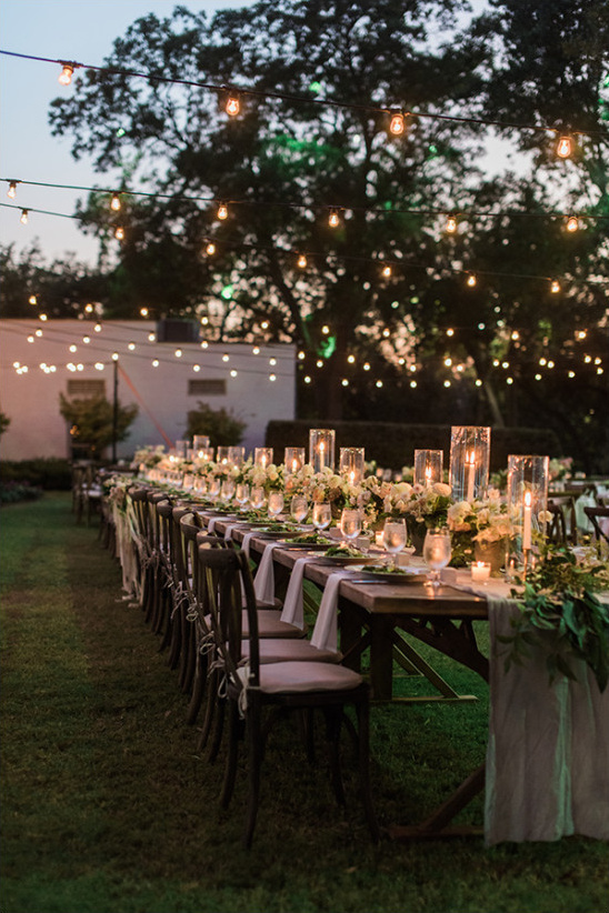 Beautiful Outdoor Wedding Reception. Table Centerpiece Decorated with Greenery and Candle Lights // 15 Stunning Ways to Decorate with Candles // http://mysweetengagement.com