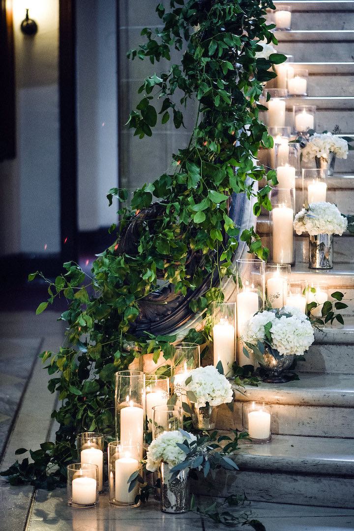 Candles and greeneries give a dramatic effect decorating a staircase. // 15 Stunning Ways to Decorate with Candles // http://mysweetengagement.com