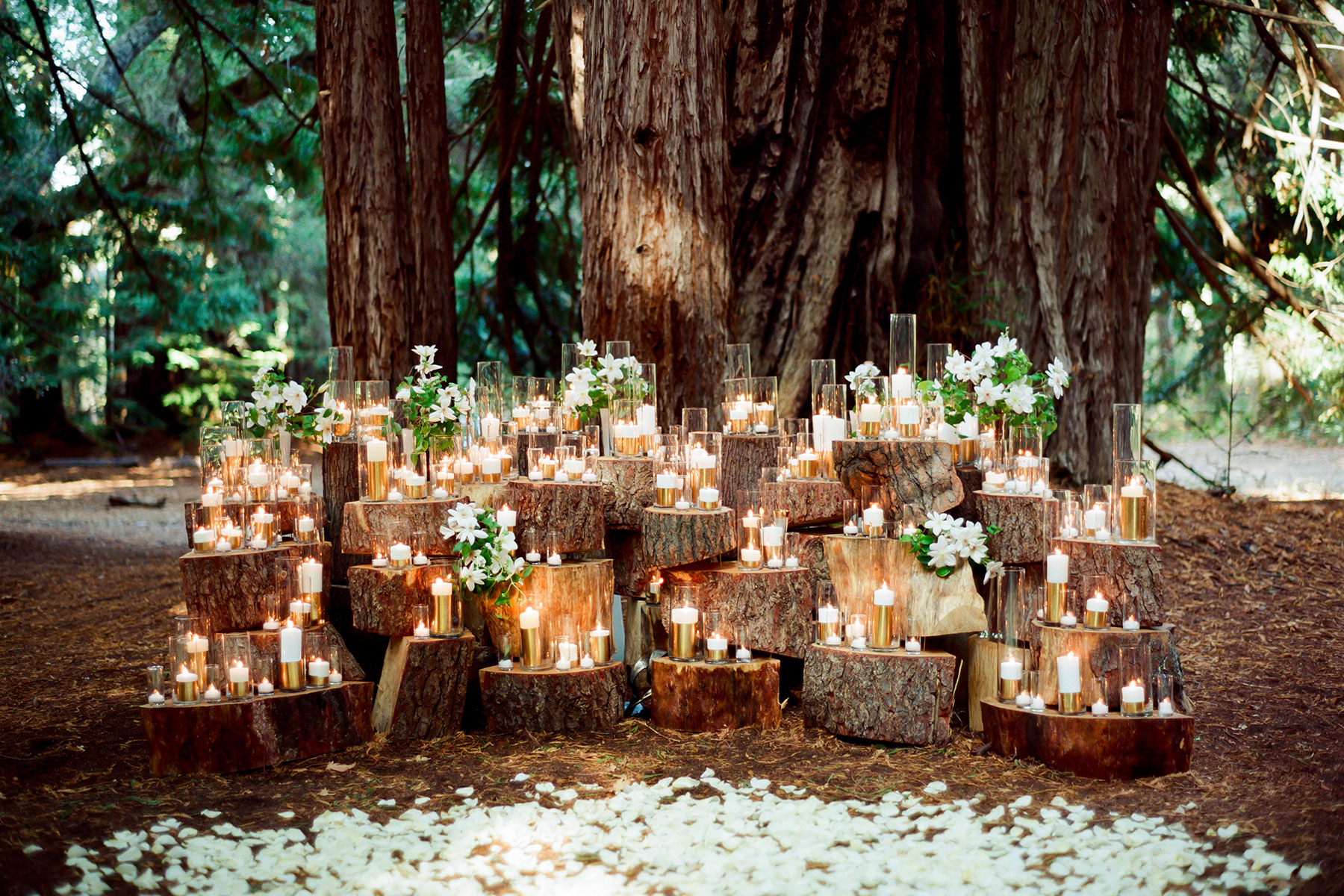 Rustic Wedding Ceremony on the Woods with Candle Backdrop and White Petals on the Floor // 15 Stunning Ways to Decorate with Candles // http://mysweetengagement.com