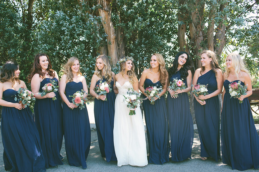Sweetheart sleeveless navy blue bridesmaid dresses with white and coral bouquet. 