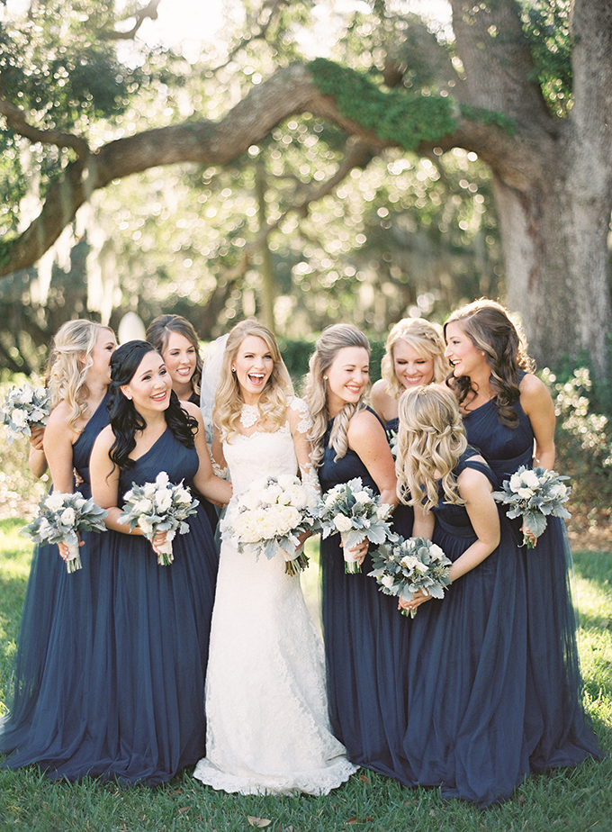 Happy bridesmaids and bride portrait inspiration. Gorgeous one shoulder navy blue bridesmaid dresses. 