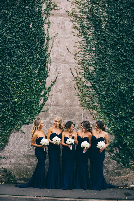Sweetheart sleeveless mermaid bridesmaid dresses and all white bouquets.