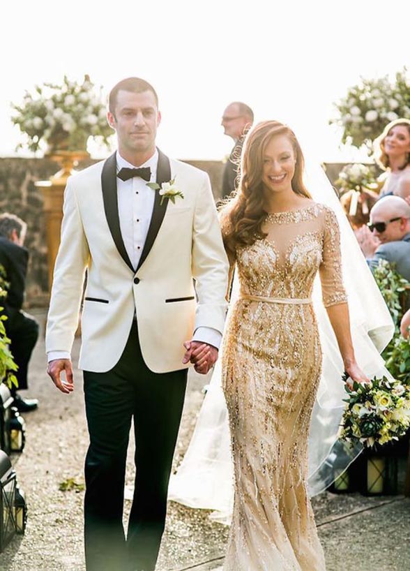 This glamorous bride and groom inspiration is perfect for a black tie wedding. Groom wears a black and white tuxedo and the bride is looking fabulous on a gold mermaid wedding dress. // mysweetengagement.com