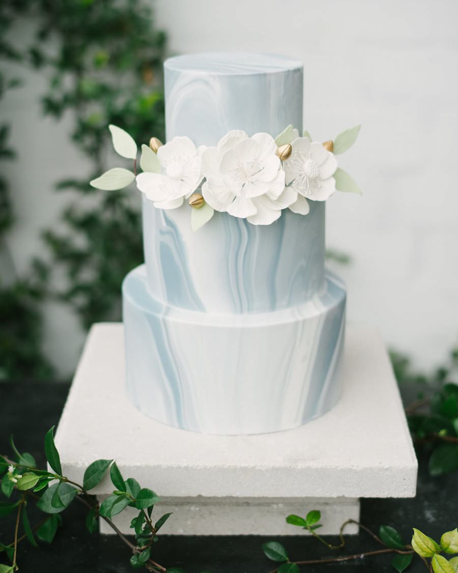 Marble themed wedding ideas: Gorgeous modern white and blue three-tiered marble cake, embellished with white flowers. // mysweetengagement.com