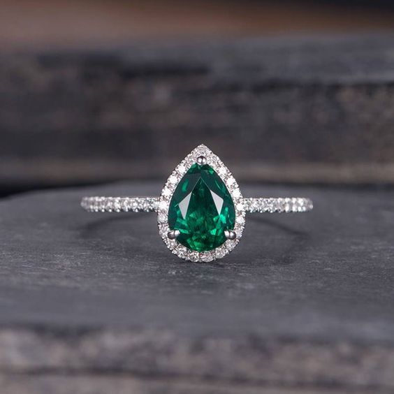 Pear shaped (teardrop) engagement ring ideas: Platinum ring with emerald stone and halo // mysweetengagement.com
