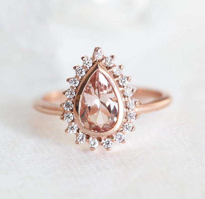 Pear shaped (teardrop) engagement ring ideas: Pear Cut Morganite Engagement Ring with Halo Diamonds. // mysweetengagement.com