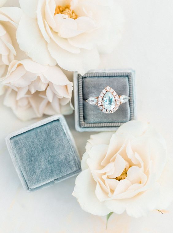 Pear shaped (teardrop) engagement ring ideas: light blue gemstone with rose gold band, pear shaped side stones and halo. // mysweetengagement.com