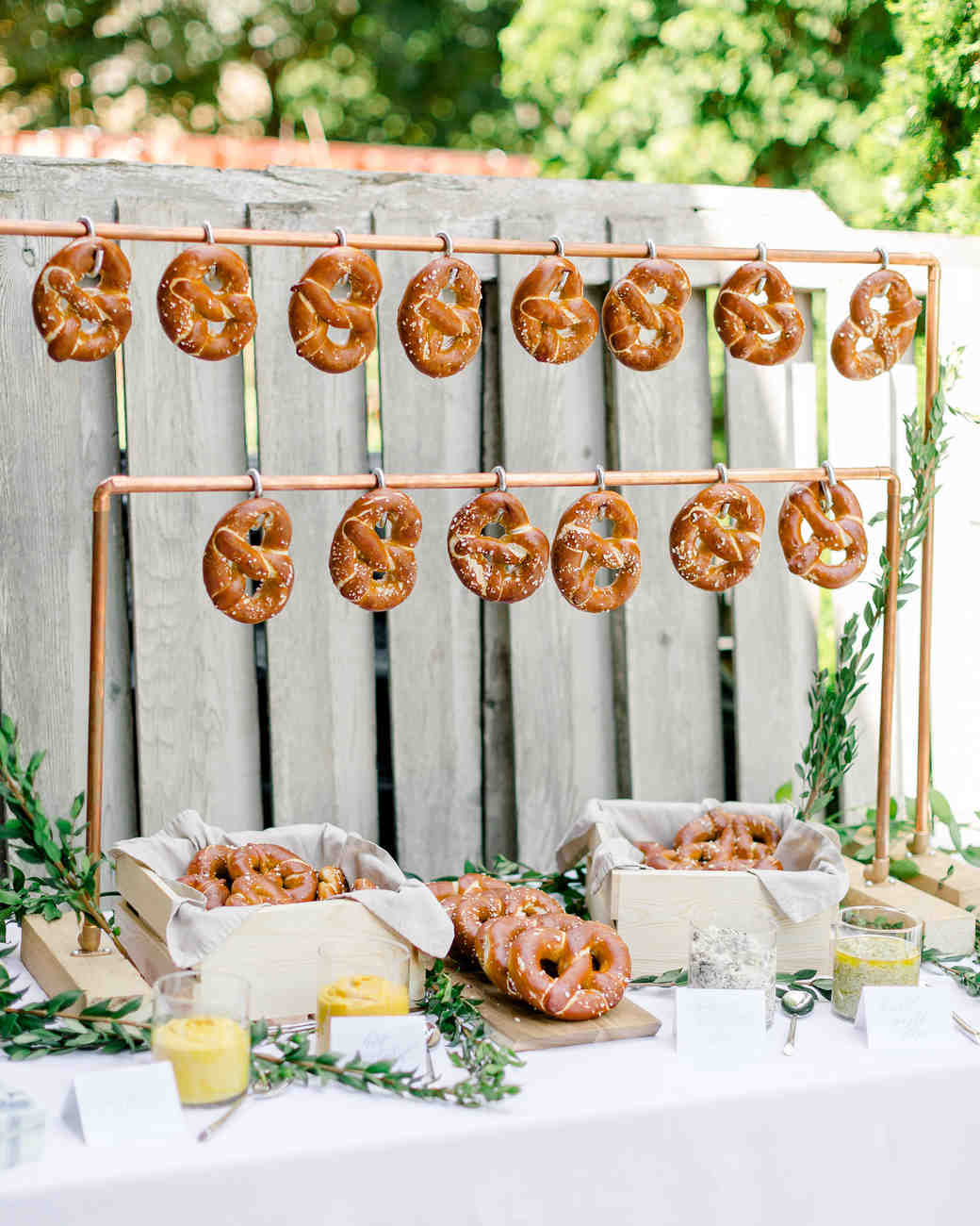 Industrial chic copper pipe soft pretzel hanging display. See More Trendy and Creative Ideas to Serve Pretzel on Your Wedding. | My Sweet Engagement