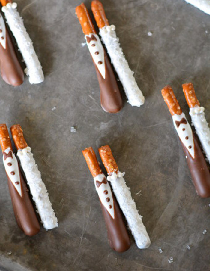 Chocolate Covered Bride and Groom Pretzel Stick Favors. See More Trendy and Creative Ideas to Serve Pretzel on Your Wedding. | My Sweet Engagement