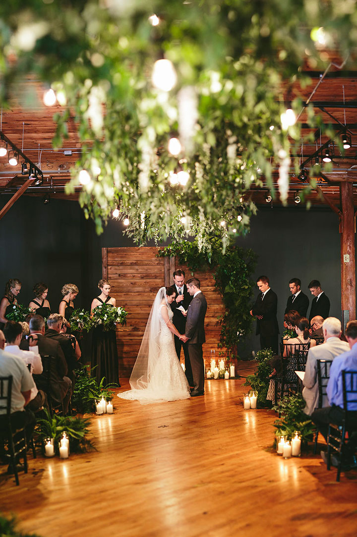 This wedding ceremony combines wood accents with lots of greens and candle lights and makes a perfect rustic-chic wedding ceremony setup. // ❤ Check Out These Gorgeous 20 Indoor Wedding Ceremony Ideas. // http://mysweetengagement.com/indoor-wedding-ceremony-ideas