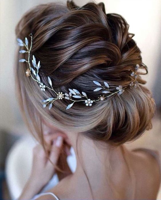 Textured hair updo idea with a dazzling wreath hairpiece.