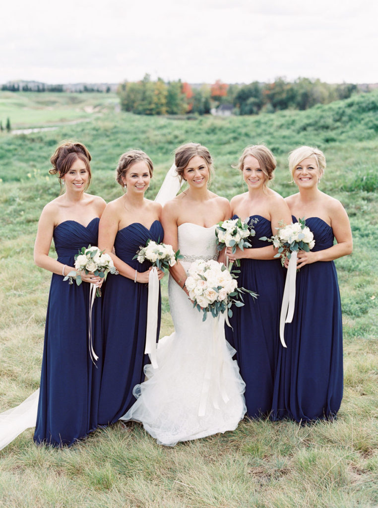 Sweetheart sleeveless bridesmaid dresses. All white wedding bouquets and classic updos. 