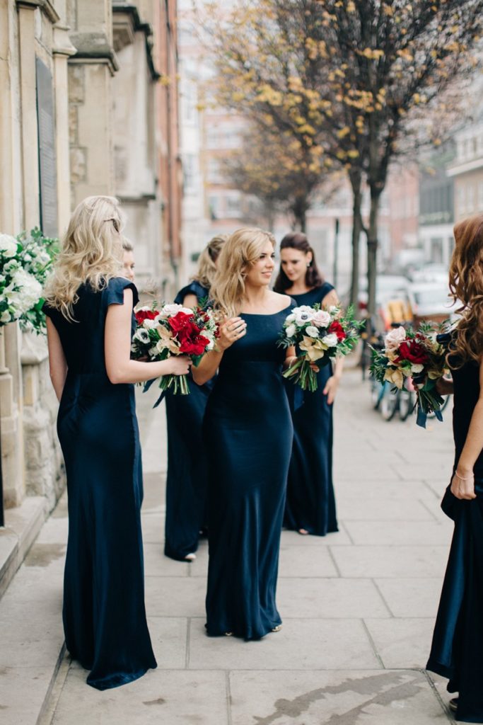 Glamorous winter navy blue velvet bridesmaid dresses inspiration and white and red bouquets.