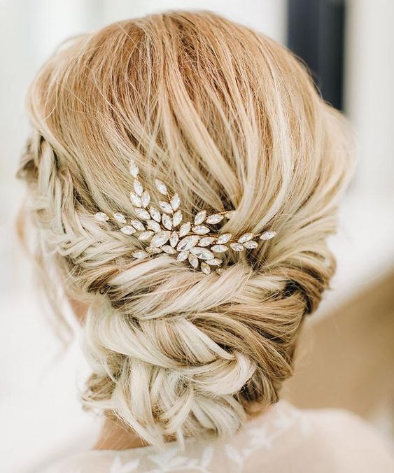 Breathtaking wedding hairstyle idea: low twisted hair bun with a delicate hairpiece. 