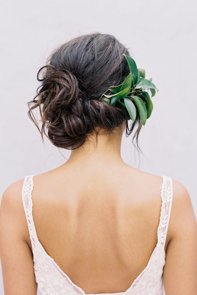 Romantic Bridal Updos // Relaxed twisted side swept bridal updo with greenery embellishments. // mysweetengagement.com