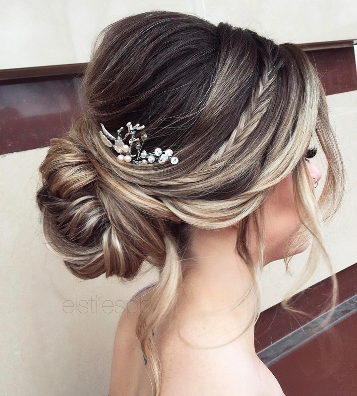 Perfectly imperfect bridal hairstyle idea with loose strands and pouf crown, embellished with hairpins and a small side braid. 