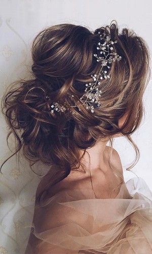 Romantic Bridal Updos // This messy wedding hair bun by Ulyana Aster is the definition of perfection! Soft curls, pouf crown and an eye-catching hairpiece. So on point! // mysweetengagement.com