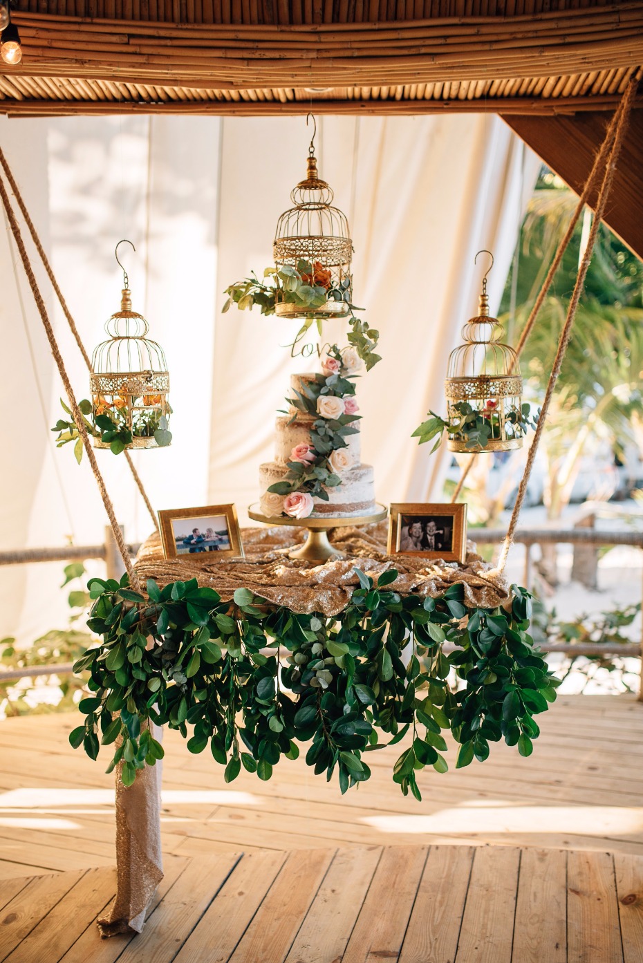 Fairytale inspired wedding cake display. Hanging dessert table embellished with lots of greenery and vintage birdcages. // Jaw-dropping suspended cake display ideas for your wedding day. // mysweetengagement.com