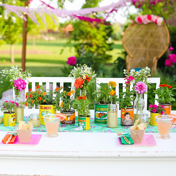 Bright and colorful 5 de Mayo backyard brunch celebration idea. For a cute centerpiece, save all your salsa cans and repurpose them with your favorite flowers. // Get inspired with these Elegant Mexican Fiesta / Cinco de Mayo Themed Bridal Shower Ideas. // mysweetengagement.com