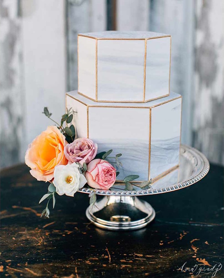 Marble themed wedding ideas: two tiered hexagonal wedding cake with gold details. // mysweetengagement.com