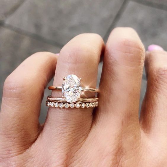 Solitaire gold oval engagement ring on a gold band. // mysweetengagement.com