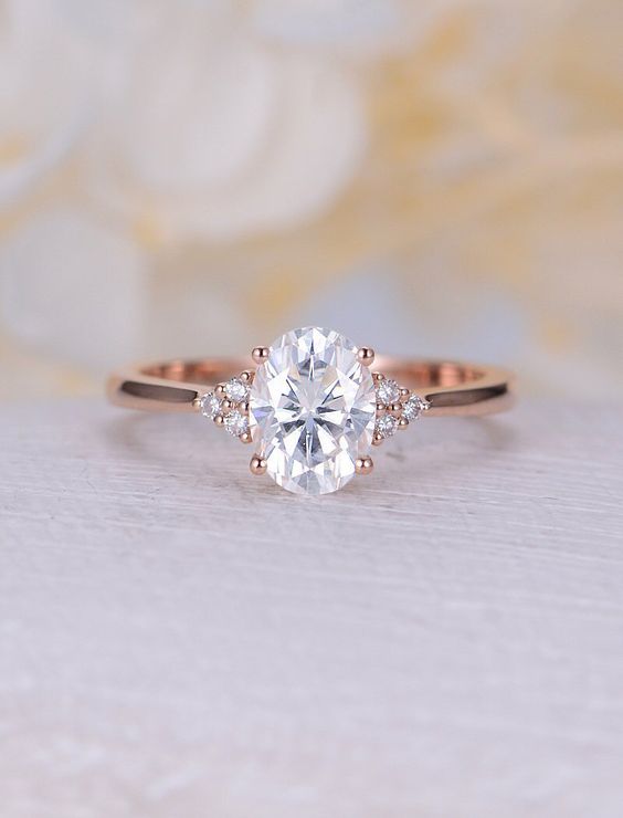 Oval engagement ring with side stones and thin gold band. // mysweetengagement.com
