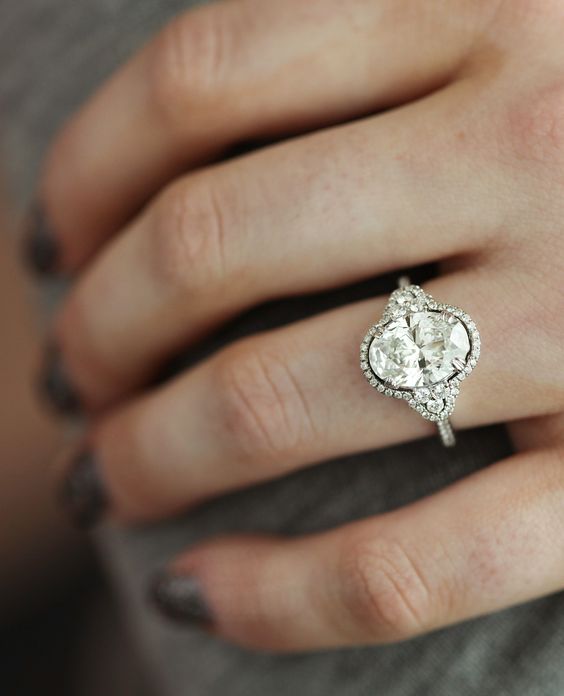 Stunning oval engagement ring with halo and side stones. // mysweetengagement.com