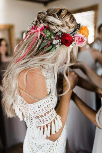 Bohemian style half up half down bridal hairstyle with braids and flowers. // Gorgeous half up half down bridal hairstyle ideas to impress on your wedding day. // mysweetengagement.com