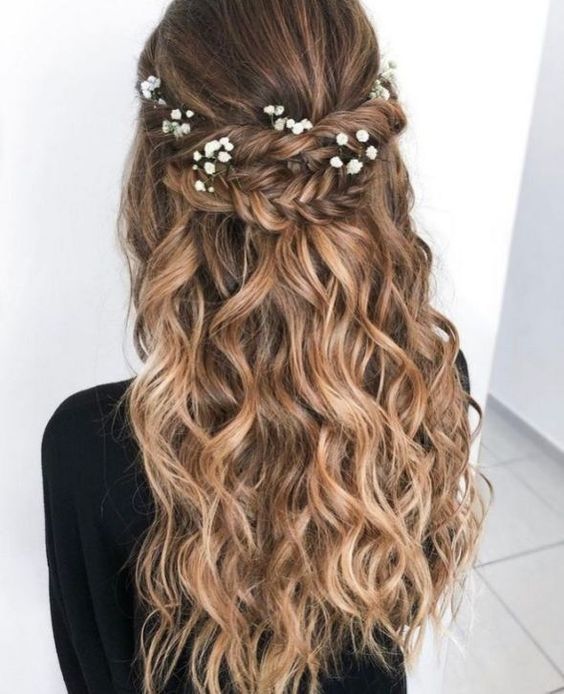 Braided half up half down hair idea with delicate flowers. // Gorgeous half up half down bridal hairstyle ideas to impress on your wedding day. // mysweetengagement.com