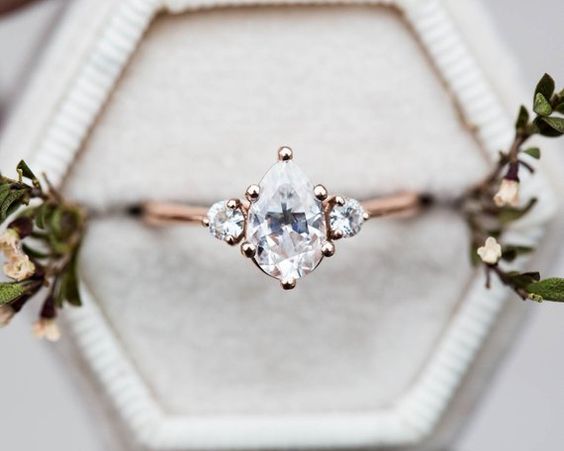 Pear shaped (teardrop) engagement ring ideas: Rose gold band and round diamond side stones. // mysweetengagement.com