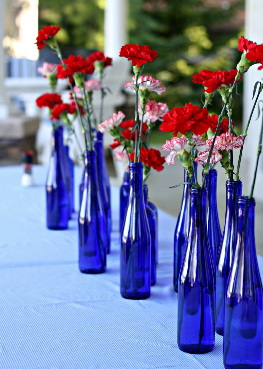 Red, White and Blue: Awesome and elegant patriotic decorations for a 4th of July theme bridal shower. // Reuse old blue bottles as floral vases for a patriotic bridal shower theme. // mysweetengagement.com