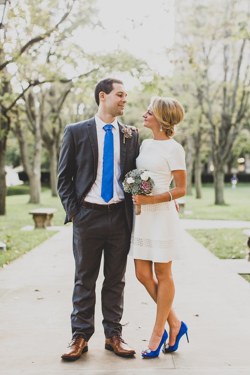 Gorgeous bride and groom wearing matching navy blue tie and shoes and a stunning little white dress. // See more: 20 Stunning Civil Wedding Outfit Ideas to Make it Official In Style. // mysweetengagement.com