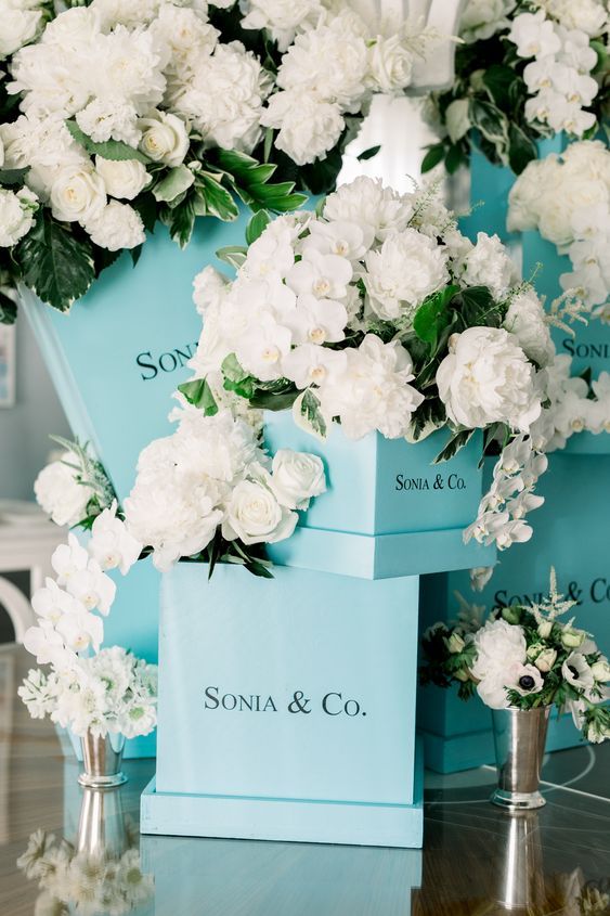 Top Creative Bridal Shower Theme Ideas. Breakfast at Tiffany's Themed Party. Tiffany blue inspired boxes filled with white roses will make a classic and elegant floral arrangement for your party. // mysweetengagement.com