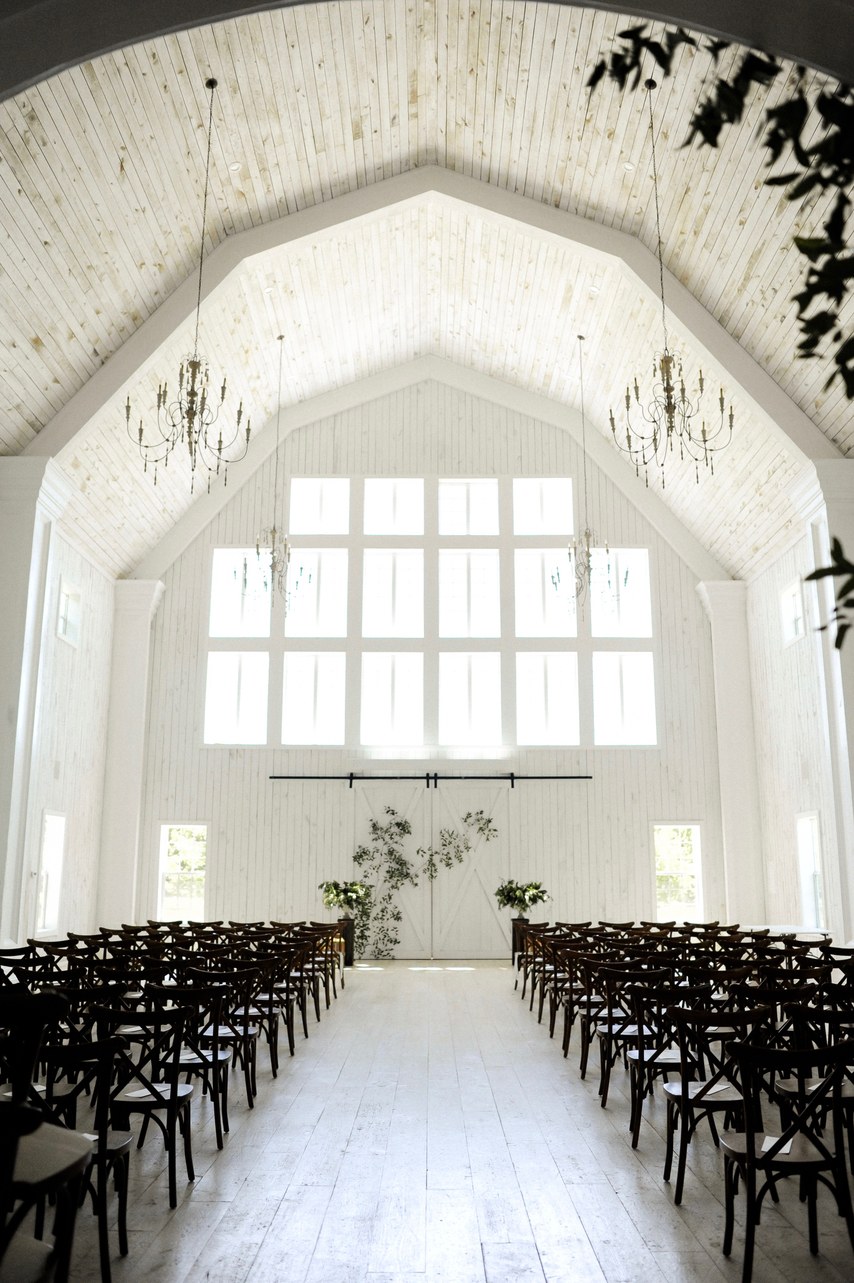 Black and white indoor ceremony setup on a rustic barn. // ❤️ Check Out These Gorgeous 20 Indoor Wedding Ceremony Ideas. // https://mysweetengagement.com/indoor-wedding-ceremony-ideas