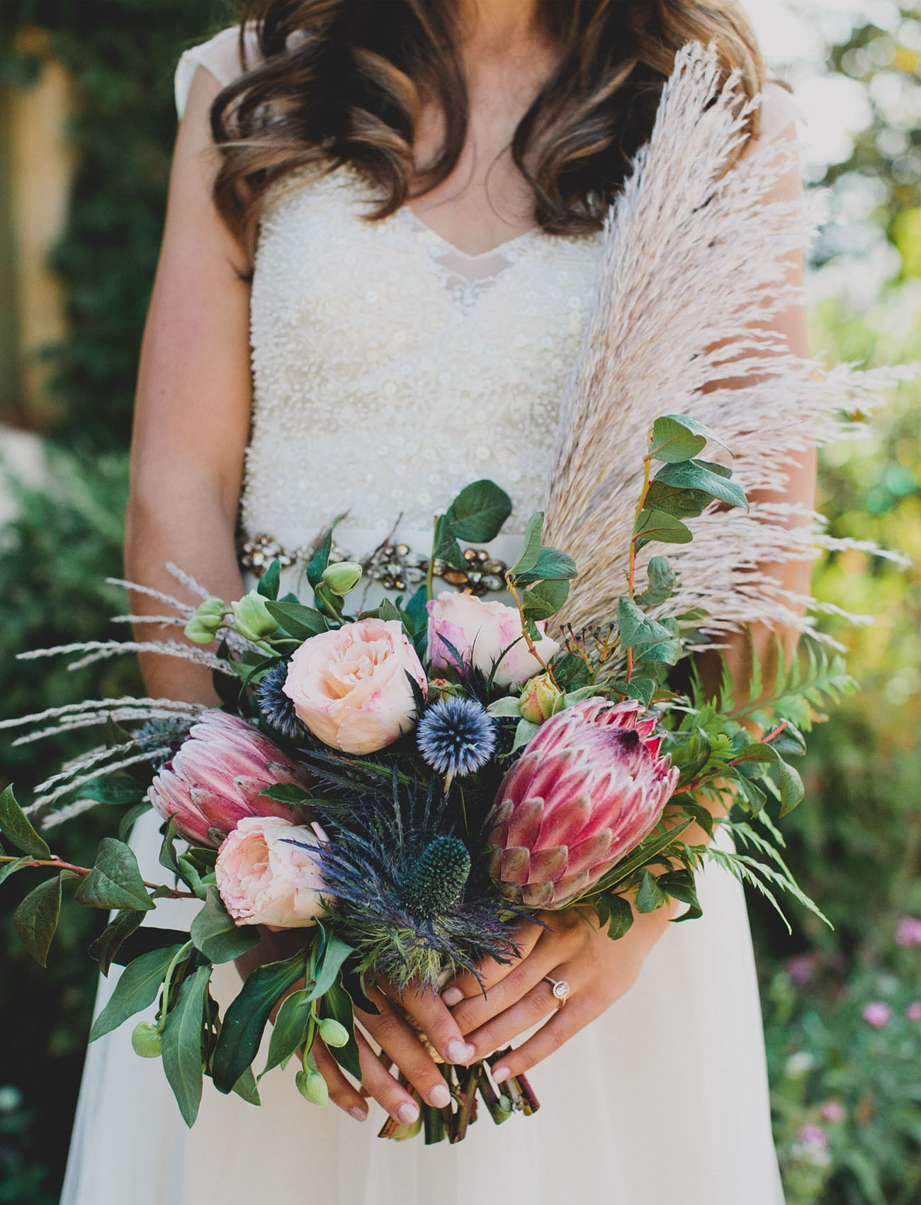 Bridal bouquet with pampas grass, greeneries and blush and blue flowers.