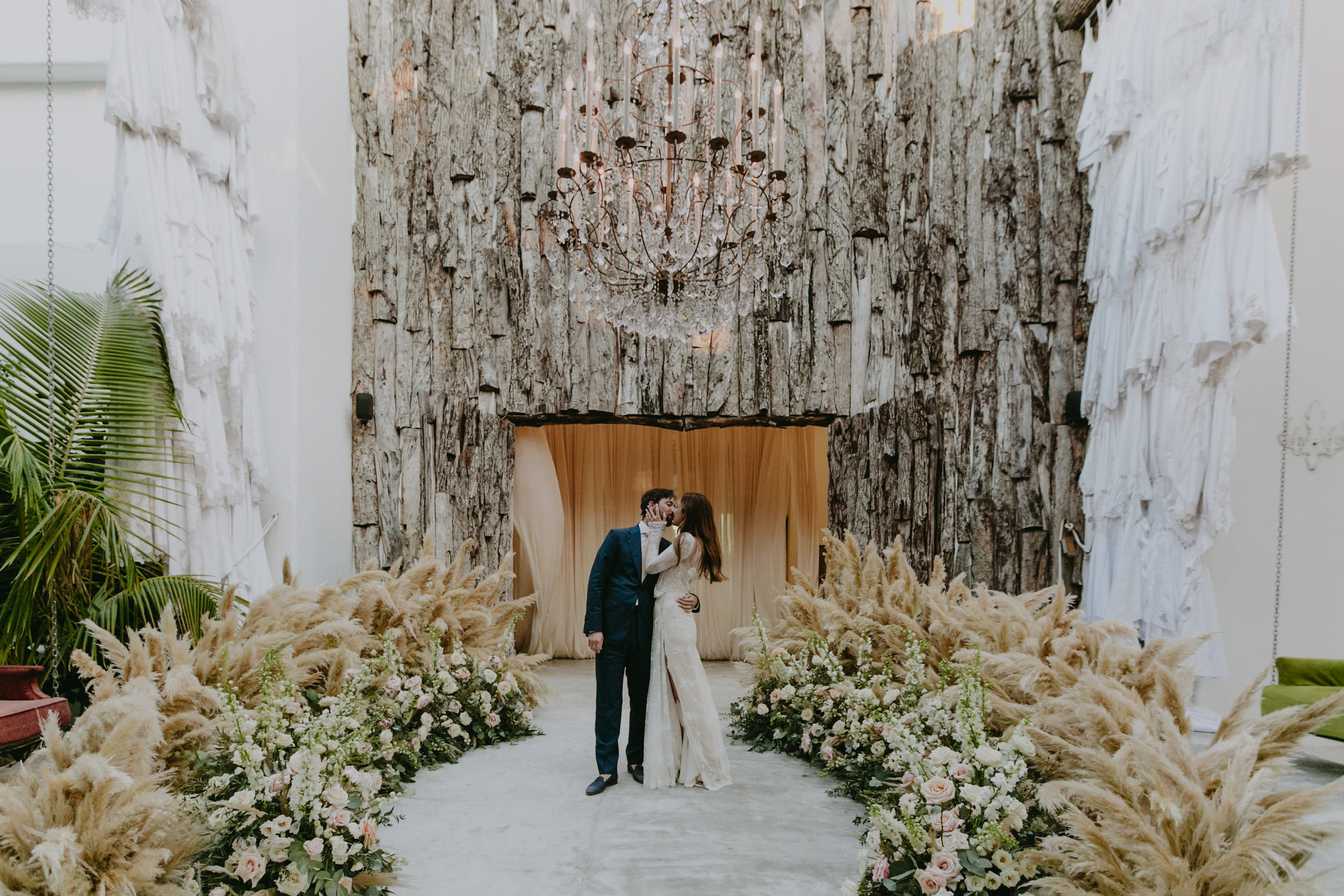 bride and groom standing on a round Cortaderia Selloana floor installation.