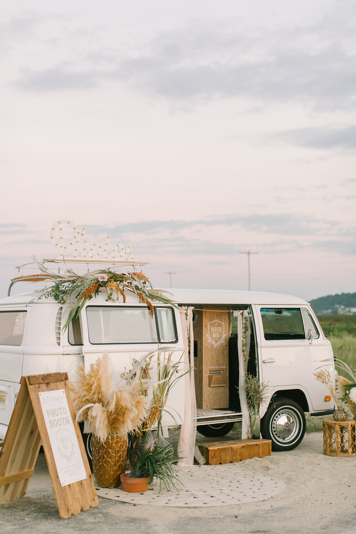 vintage Volkswagen van used for a wedding photo op decorated with boho style elements and pampas grass