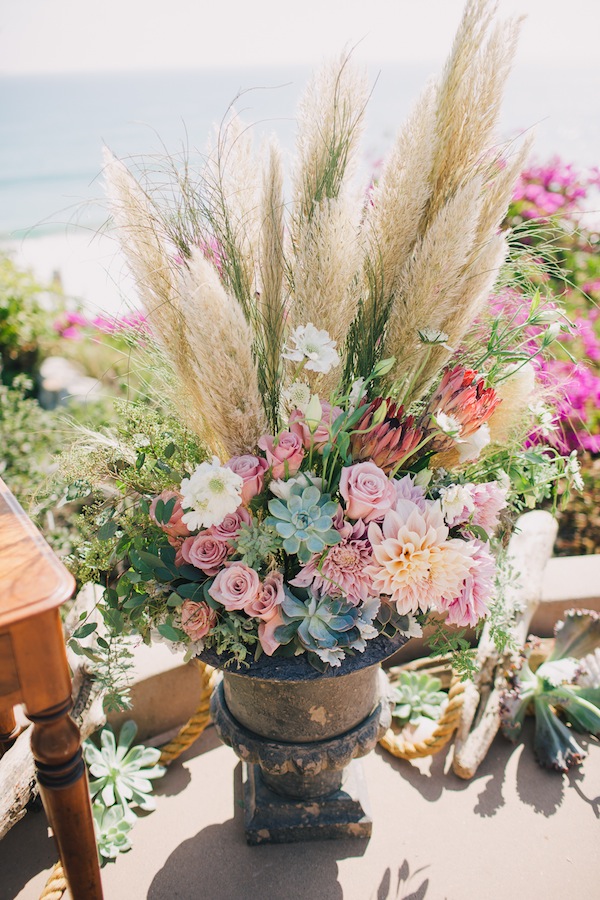 Wedding floral arrangement with Cortaderia Selloana, succulents and pink roses and dahlias.