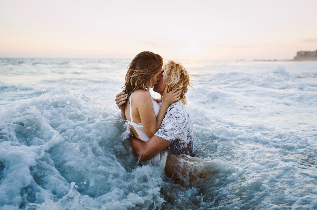 couple kissing in the ocean on a beach engagement photoshoot