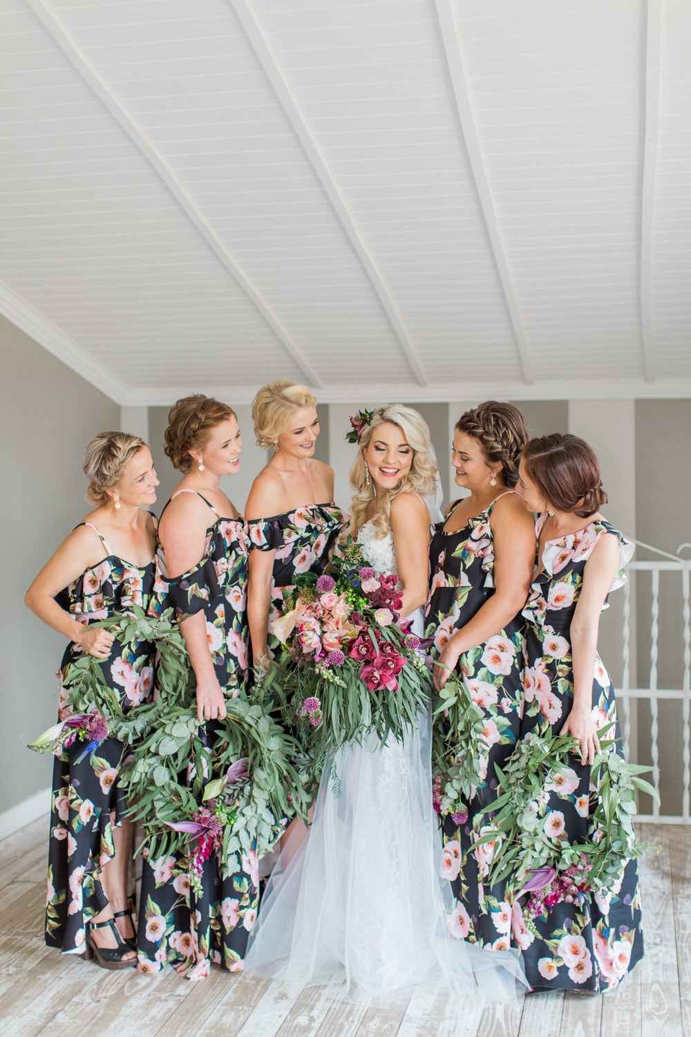 navy blue floral bridesmaid dresses paired with greenery hoops