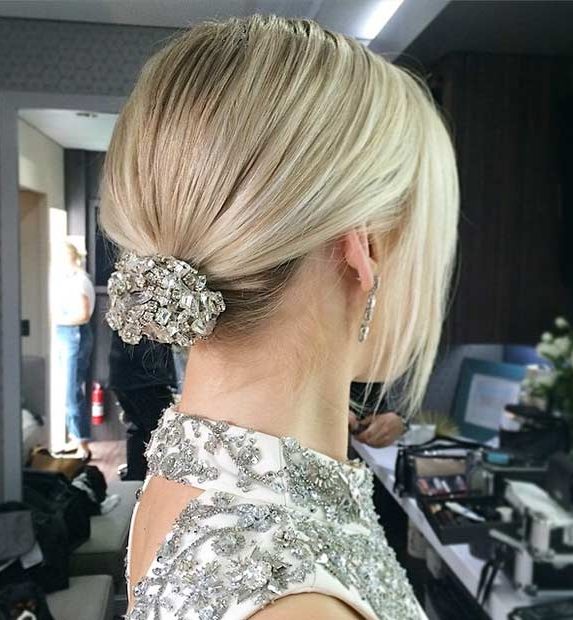 chic minimalist bridal hairstyle on fine straight blonde hair: ponytail bun with strass accessory